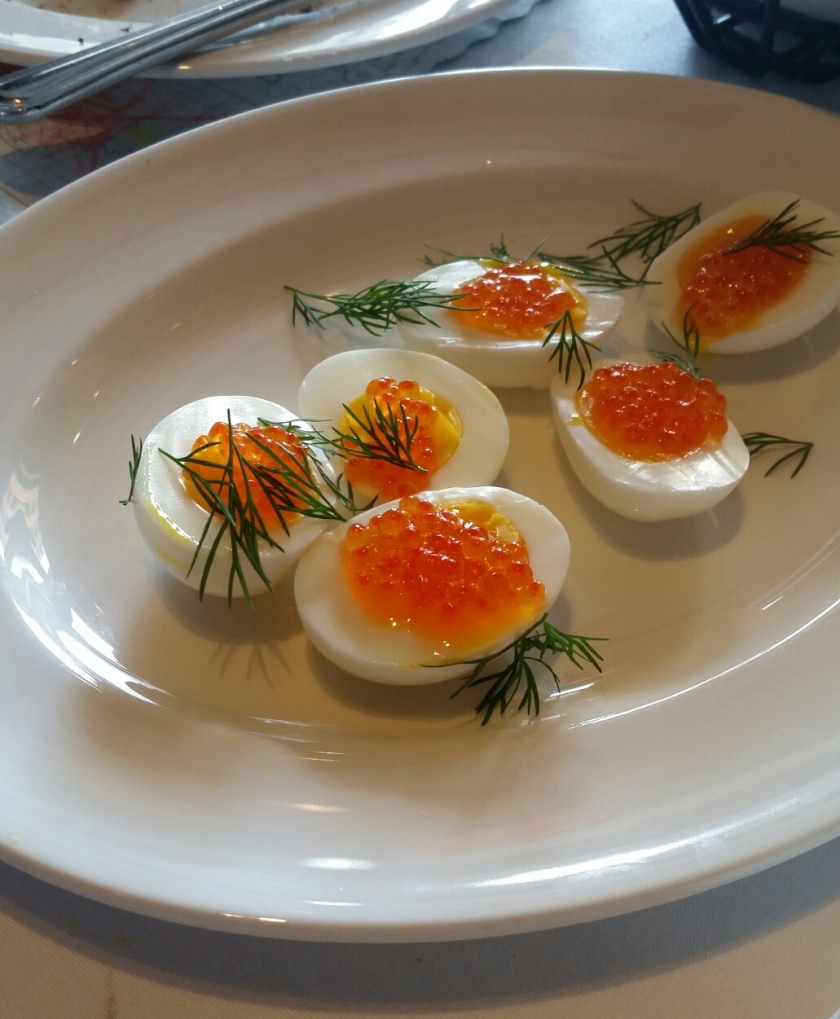 Hard-boiled eggs topped with salmon roe and fill on the table with natural